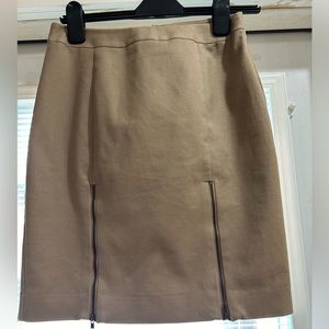 Tan skirt fully lined with zippers in the front.